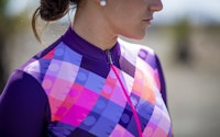 Close-up of a cyclist wearing a colorful, geometric-patterned jersey.
